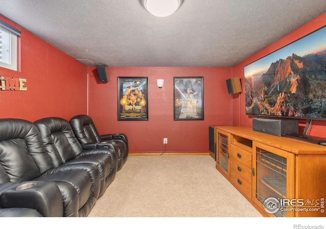 carpeted cinema room with a textured ceiling and baseboards