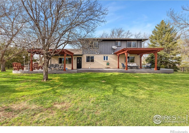 back of house featuring a patio area, a pergola, brick siding, a lawn, and board and batten siding