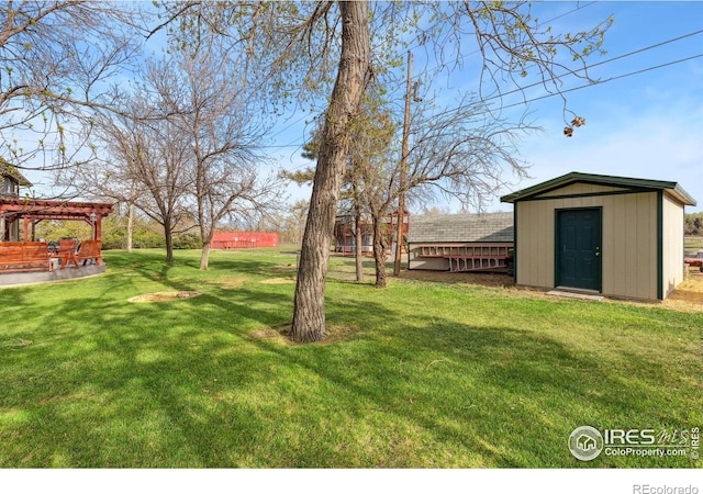 view of green lawn featuring a shed, a pergola, and an outdoor structure