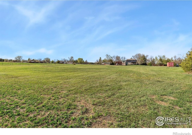 view of grassy yard with a view of countryside