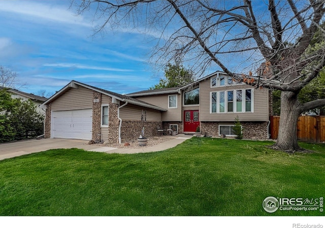 1561 Belmont Dr, Longmont, CO 80503 - split foyer home with an attached garage, concrete driveway, and brick siding