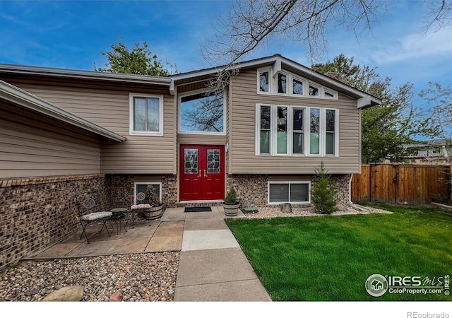 1561 Belmont Dr, Longmont, CO 80503 - property entrance featuring a patio area and brick siding