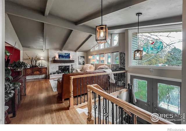 1561 Belmont Dr, Longmont, CO 80503 - living area with hardwood / wood-style floors, a brick fireplace, and french doors