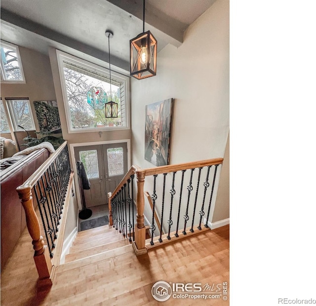 1561 Belmont Dr, Longmont, CO 80503 - stairway with wood finished floors, french doors, and baseboards