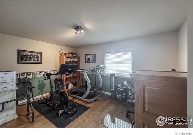 1561 Belmont Dr, Longmont, CO 80503 - exercise area featuring wood finished floors and baseboards
