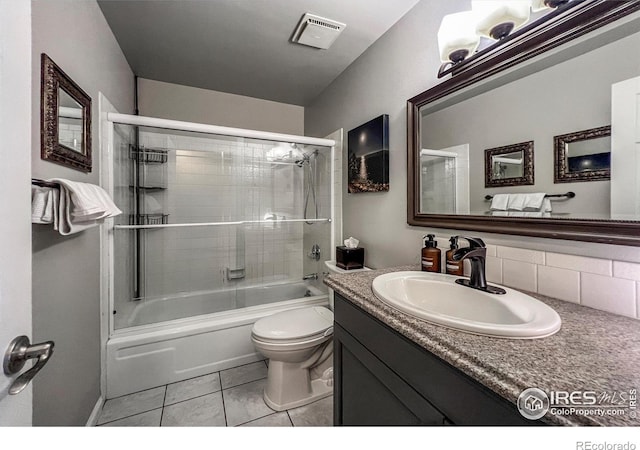 1561 Belmont Dr, Longmont, CO 80503 - bathroom with toilet, enclosed tub / shower combo, vanity, and tile patterned floors