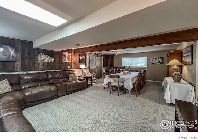 1561 Belmont Dr, Longmont, CO 80503 - carpeted living area featuring wood walls and beam ceiling