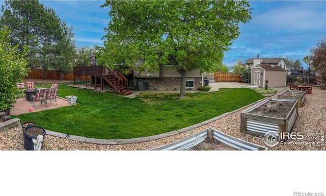 1561 Belmont Dr, Longmont, CO 80503 - view of yard with a vegetable garden, a patio, stairway, and central air condition unit