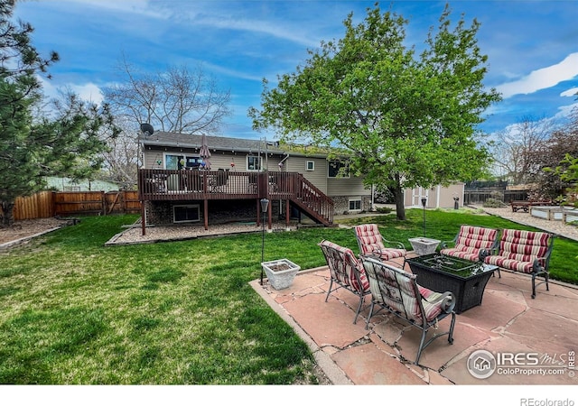 1561 Belmont Dr, Longmont, CO 80503 - rear view of house with a wooden deck, stairs, an outdoor living space with a fire pit, and a patio