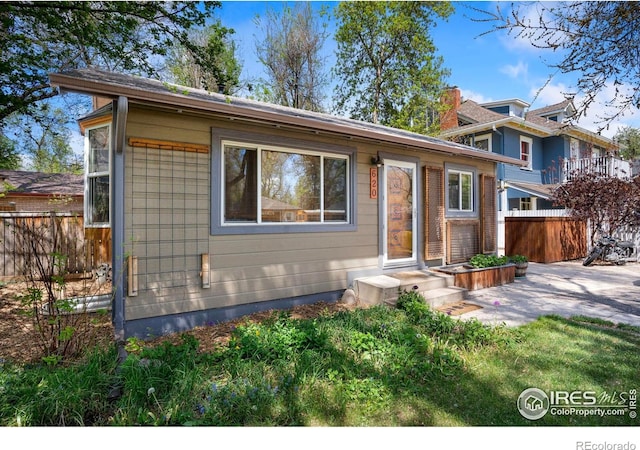 split level home featuring fence and a patio area