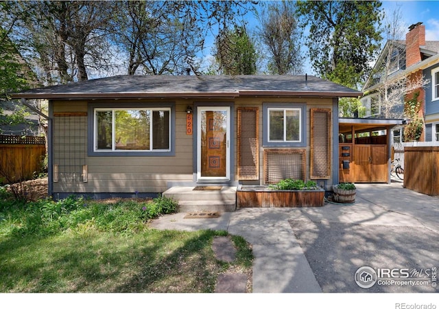 view of front of home featuring fence and a patio