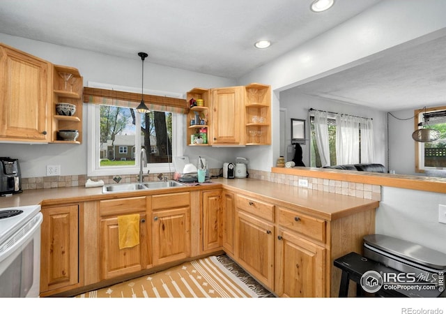 kitchen featuring open shelves, a sink, plenty of natural light, and recessed lighting