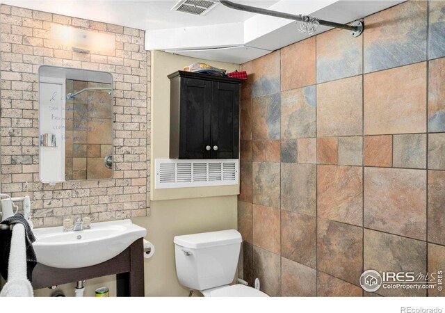 bathroom with toilet and a sink