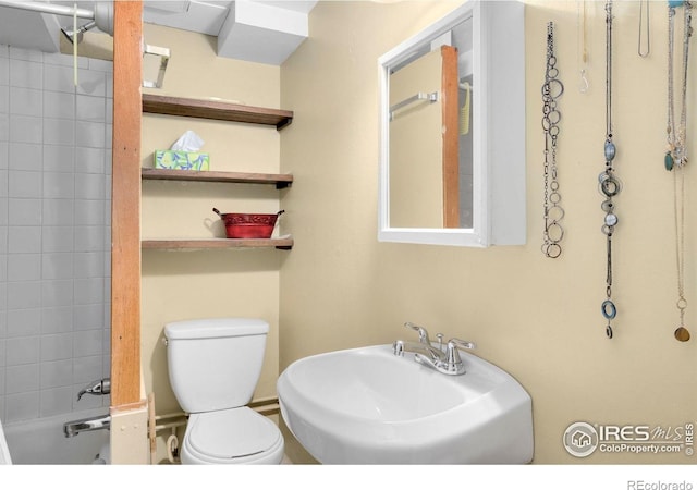 bathroom with toilet and a sink