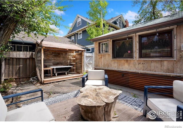 view of patio / terrace with fence and a deck