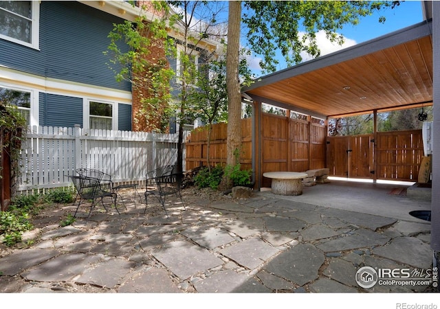 view of patio / terrace featuring fence and a gate