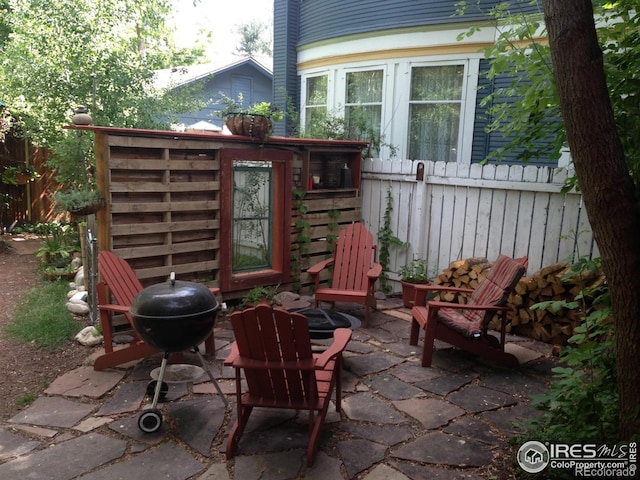 view of patio featuring fence