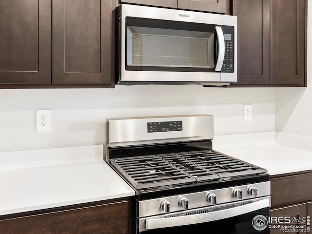 kitchen featuring stainless steel appliances, dark brown cabinetry, and light countertops