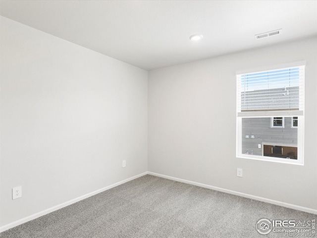 carpeted empty room featuring baseboards and recessed lighting