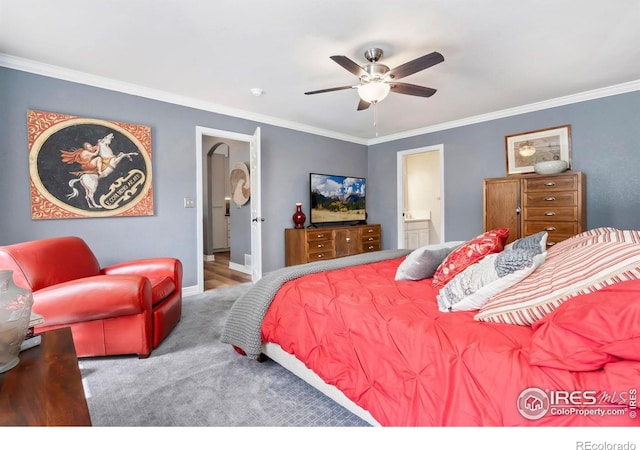 bedroom featuring ornamental molding, carpet, connected bathroom, ceiling fan, and baseboards