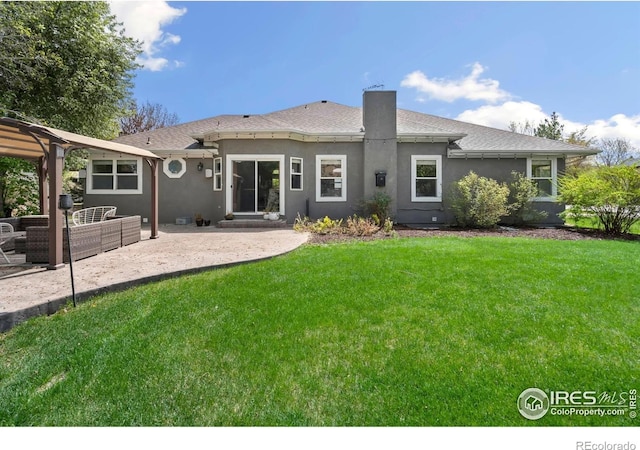 rear view of property with a patio area, an outdoor living space, a lawn, stucco siding, and a shingled roof