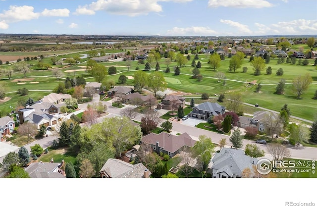aerial view of residential area with a local golf course