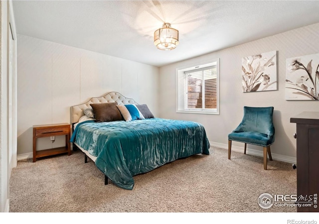 bedroom with carpet floors, a textured ceiling, and baseboards