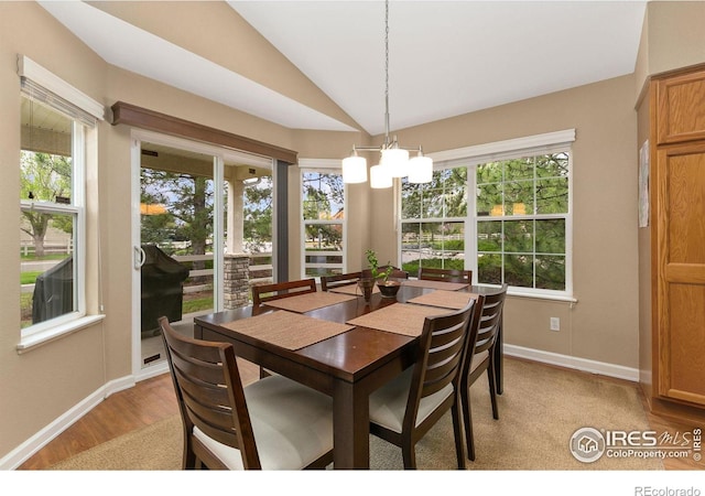 1380 Swainson Rd, Eaton, CO 80615 - dining space with vaulted ceiling, baseboards, light wood-style flooring, and a chandelier