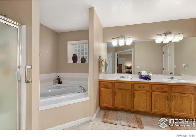 1380 Swainson Rd, Eaton, CO 80615 - full bathroom with tile patterned flooring, a bath, double vanity, and an enclosed shower