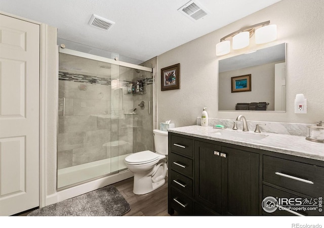 1380 Swainson Rd, Eaton, CO 80615 - full bath with toilet, wood finished floors, a shower stall, and vanity