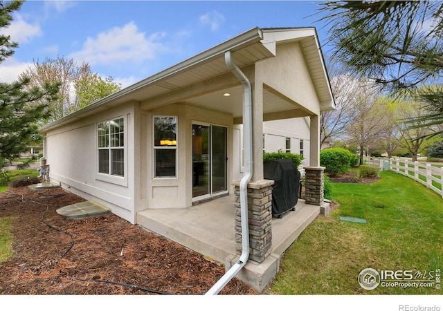 1380 Swainson Rd, Eaton, CO 80615 - view of property exterior featuring stucco siding and a patio