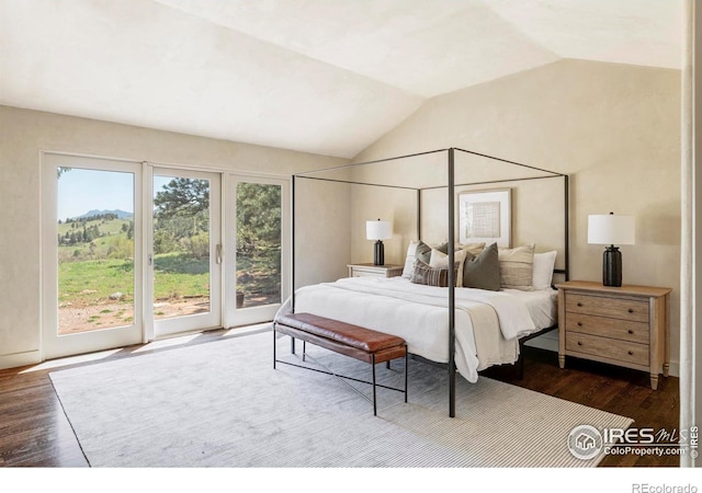 bedroom with access to exterior, lofted ceiling, and dark wood-type flooring