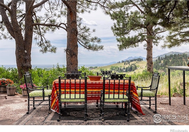 view of patio with a mountain view and a playground