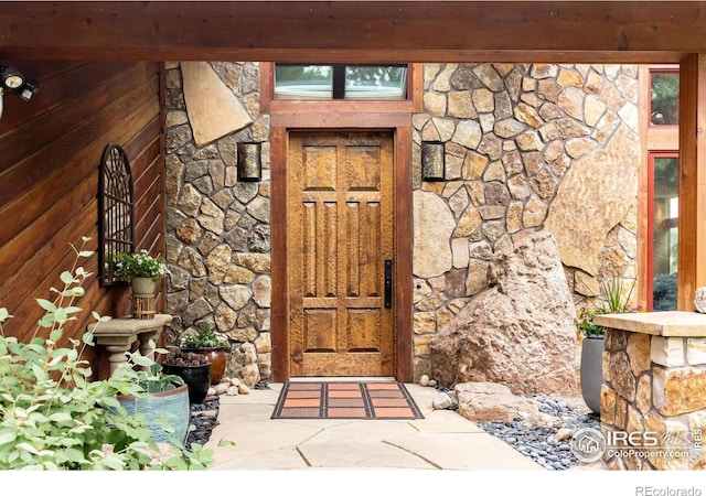 entrance to property with stone siding