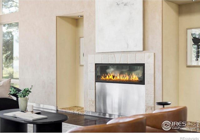 detailed view of wood finished floors and a tile fireplace