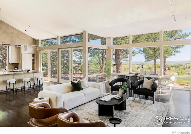 sunroom / solarium featuring lofted ceiling