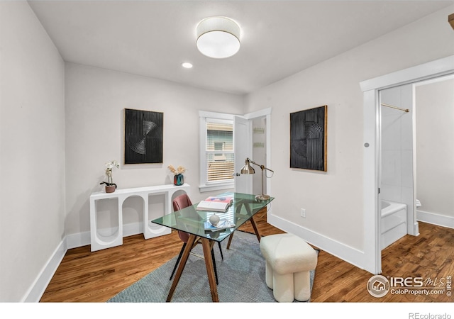 office featuring wood finished floors, baseboards, and recessed lighting