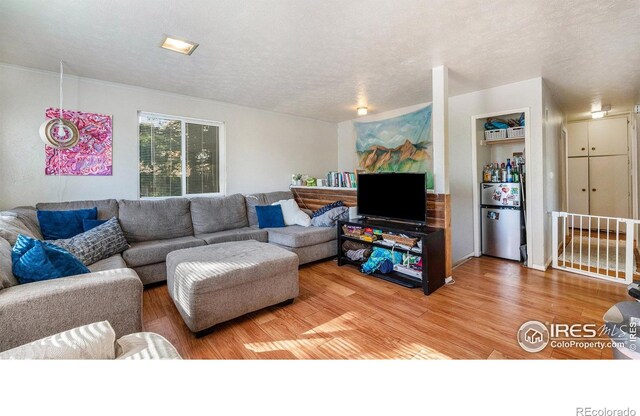879-881 19th St, Boulder, CO 80302 - living room featuring light wood-style flooring and a textured ceiling