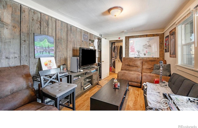 879-881 19th St, Boulder, CO 80302 - living room with light wood-style flooring, wood walls, and stacked washer / drying machine