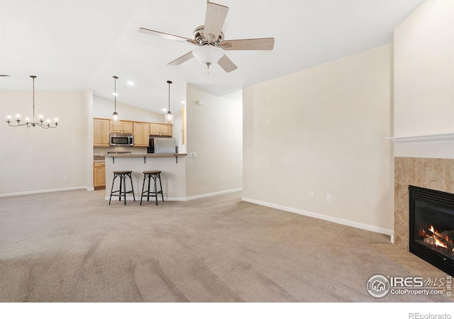 2502 Owens Ave Unit 201, Fort Collins, CO 80528 - living area featuring light colored carpet, lofted ceiling, a fireplace, and baseboards