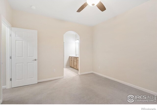 2502 Owens Ave Unit 201, Fort Collins, CO 80528 - spare room with arched walkways, a ceiling fan, carpet floors, and baseboards