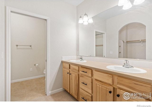 2502 Owens Ave Unit 201, Fort Collins, CO 80528 - bathroom with double vanity, toilet, and tile patterned flooring