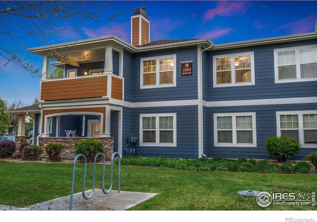 2502 Owens Ave Unit 201, Fort Collins, CO 80528 - view of front of property featuring a balcony, a chimney, and a front yard