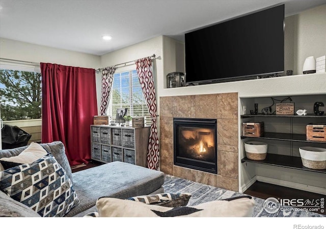 bedroom with a fireplace, wood finished floors, and recessed lighting