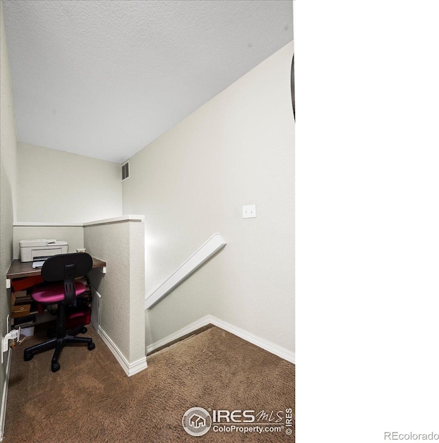 carpeted office featuring baseboards