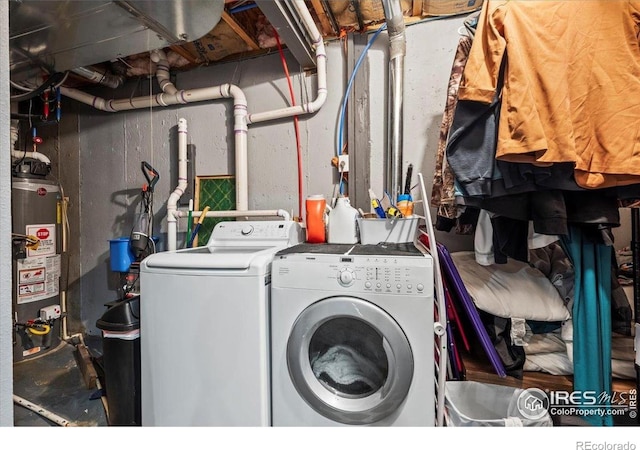 laundry area with water heater and washer and dryer