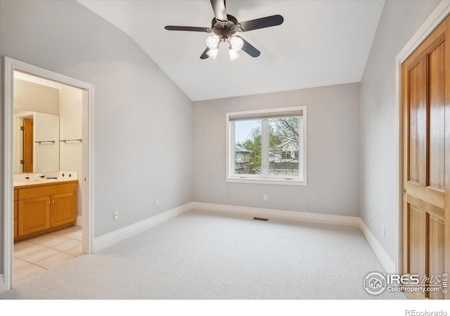 4059 Nevis St, Boulder, CO 80301 - unfurnished bedroom with light colored carpet, vaulted ceiling, ensuite bathroom, and a ceiling fan
