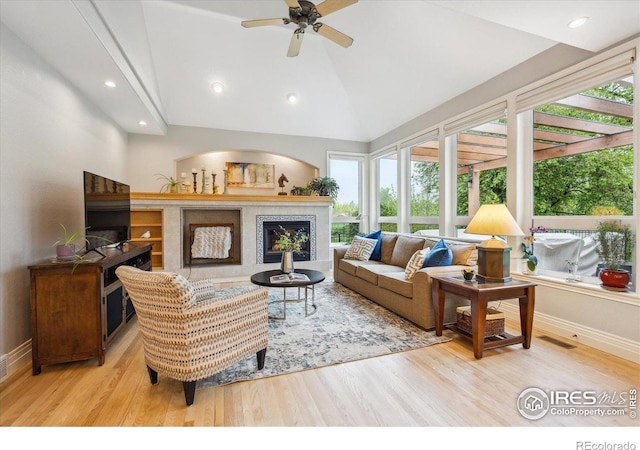 4059 Nevis St, Boulder, CO 80301 - living area featuring plenty of natural light, wood finished floors, a glass covered fireplace, recessed lighting, and high vaulted ceiling