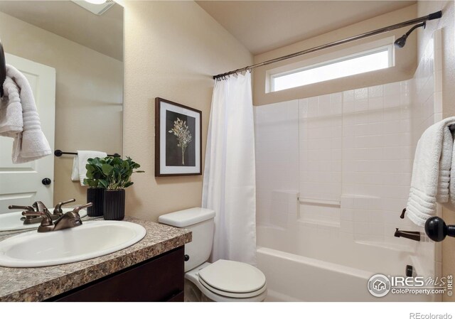 bathroom featuring toilet, vanity, and shower / bath combination with curtain