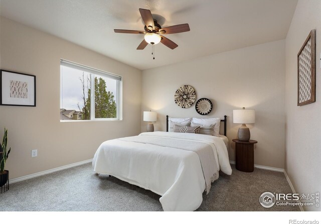 carpeted bedroom with baseboards and a ceiling fan